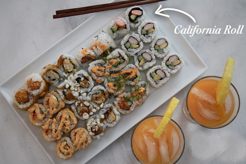 sushi on white platter served on marble counter