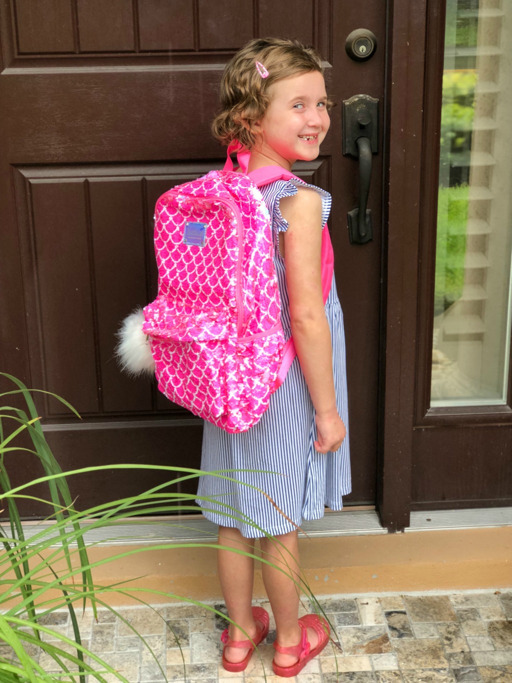 little girl wearing flip sequin backpack