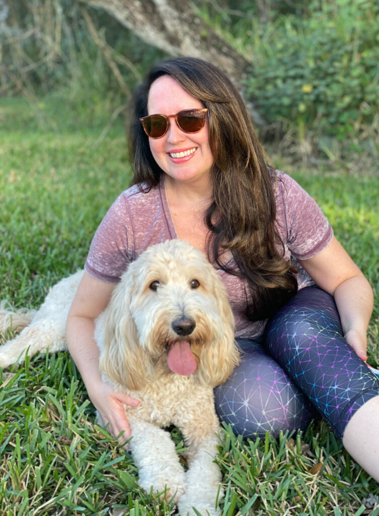 brown haired woman holding apricot goldendoodle
